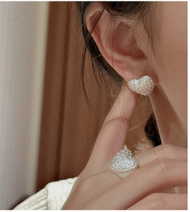 Detail of S925 silver heart earrings and ring set with unique textured relief finish