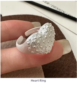 Macro view of S925 sterling silver heart ring showing relief texture and S925 hallmark