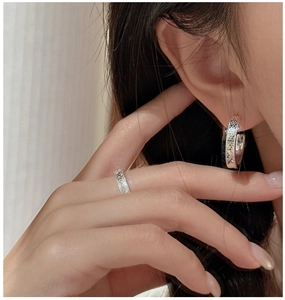 Detailed view of sterling silver honeycomb ring and earrings with shimmering texture