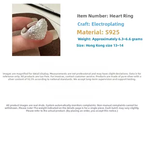 Detailed macro of S925 sterling silver heart ring with grainy texture and matte finish