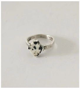 Detailed close-up of retro hammered silver ring featuring a round dalmatian stone inlay