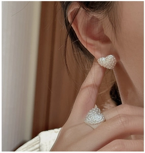Detail of S925 sterling silver heart earrings and ring with vintage hammered texture