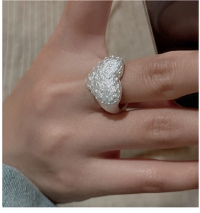 Close-up of S925 sterling silver heart ring with retro textured surface on model