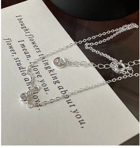 Detailed shot of S925 sterling silver necklace with single zircon and AG925 hallmark