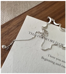 Detail of silver crescent moon link bracelet with adjustable sliding box chain mechanism