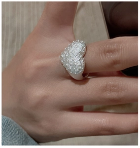 Close-up of heart-shaped S925 silver ring with vintage hammered texture on a model hand