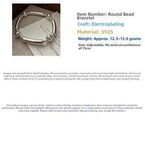Macro detail of S925 sterling silver elastic bracelet with polished beads and silver tubes