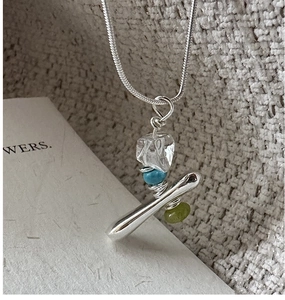 Macro shot of S925 silver necklace featuring irregular crystal and colorful bead charms