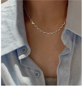 Detail of S925 sterling silver crescent moon necklace with sparkling stones on model