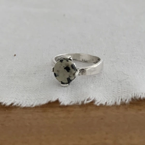 Retro 925 sterling silver ring with round Dalmatian Jasper stone on white fabric