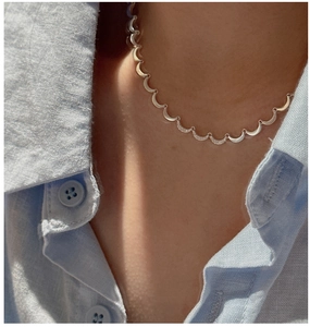 Macro detail of S925 sterling silver crescent moon necklace with zircon stones inlay