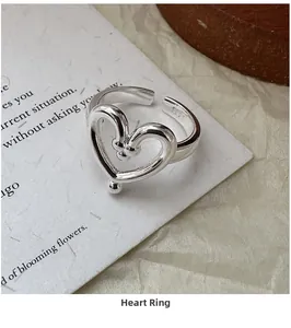 Detailed view of S925 sterling silver heart ring with engraved hallmark and adjustable band