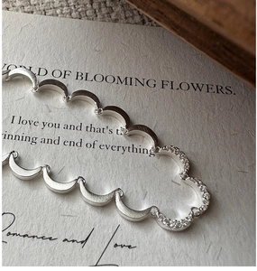 Detail view of S925 sterling silver crescent necklace with matte and paved diamond texture