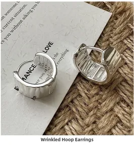 Macro shot of S925 sterling silver stamp on vintage wrinkled textured hoop earrings