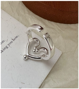 Detail view of S925 sterling silver heart ring showing the hallmark stamp and finish