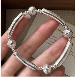 Detailed close-up of S925 sterling silver watermelon beads and polished metal tubes bracelet
