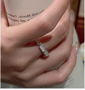 Detail of S925 sterling silver bamboo ring with zircons on model holding a cup