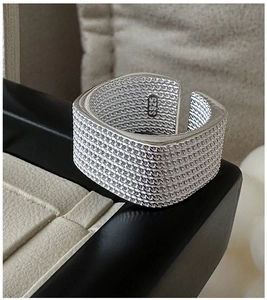Macro shot of S925 sterling silver wide band ring showing intricate woven chain texture