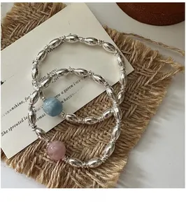 Detailed close-up of S925 silver beaded bracelets with pink and blue accent stones