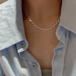 Minimalist S925 sterling silver moon necklace with pavé zircon stones on a female model