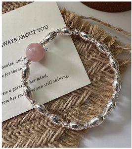 Detailed shot of S925 silver rice beads bracelet featuring a soft pink gemstone accent