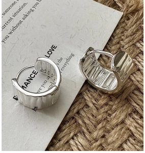 Detail of S925 sterling silver hoop earrings with vintage hammered texture finish