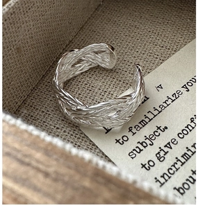 Detailed shot of S925 sterling silver braided ring inside a linen jewelry box