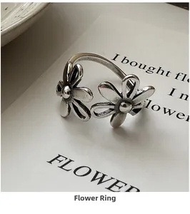 Detailed macro view of vintage S925 silver flower ring with adjustable open band texture
