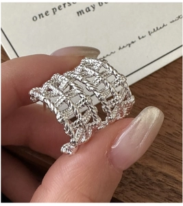 Detailed view of S925 sterling silver ring with delicate hollow mesh woven texture design