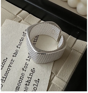Detailed macro shot of S925 sterling silver ring with woven mesh texture and hallmark