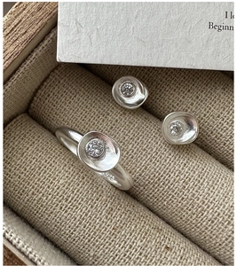 Macro shot of S925 sterling silver ring and earrings set with zircons in a jewelry box