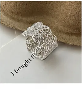 Close-up of vintage lace hollow wide ring in S925 sterling silver with woven texture
