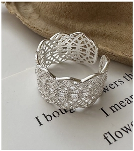 Detail of S925 silver wide lace ring with hollow woven texture and adjustable open band