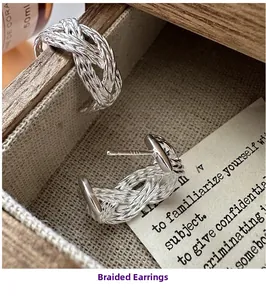 Detail view of woven S925 sterling silver hoop earrings with vintage braided metal texture