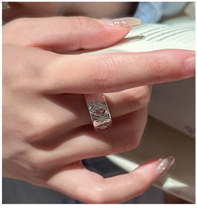 Close-up of retro S925 sterling silver wide band ring with engraved star patterns