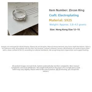 Detail of S925 sterling silver ring featuring vertical stripes and a single zircon