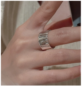 Close-up of S925 sterling silver ring featuring a unique wrinkled texture on a finger