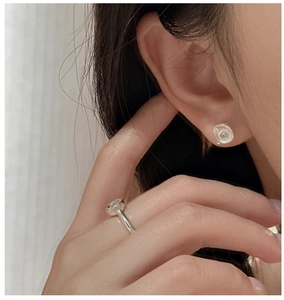 Close-up of minimalist S925 sterling silver matte earrings and ring with zircon stones