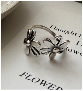 Macro detail of vintage floral S925 sterling silver ring with daisy petal texture