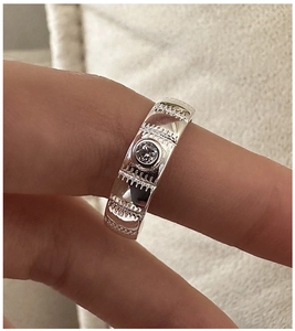 Macro view of textured S925 sterling silver ring band with a single inset zircon stone