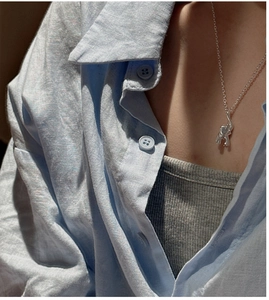 Close-up of minimalist S925 sterling silver elephant pendant necklace on a model