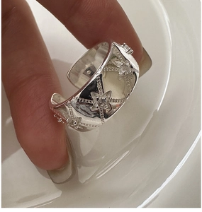 Macro shot of silver S925 star ring with zircons and vintage beaded edge detail
