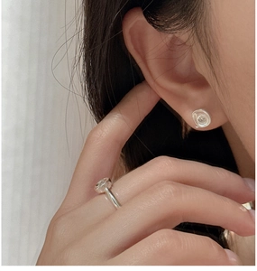 Detailed view of S925 sterling silver earrings and ring set with round clear zircon