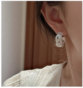 Close-up of S925 sterling silver woven hoop earrings on model showing vintage texture