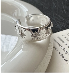 Macro detail of S925 sterling silver star ring with cubic zirconia and lattice patterns