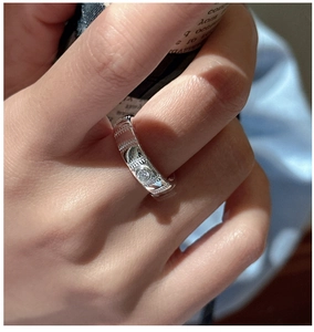 Detail of S925 sterling silver ring with textured band and single cubic zirconia stone