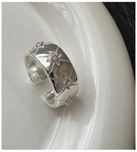 Macro shot of S925 sterling silver star ring featuring sparkling zircon and vintage texture