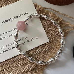 Minimalist S925 sterling silver beaded bracelet featuring a pink crystal bead on rustic linen