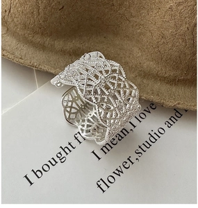 Detailed view of S925 silver wide band ring featuring intricate lace hollow patterns
