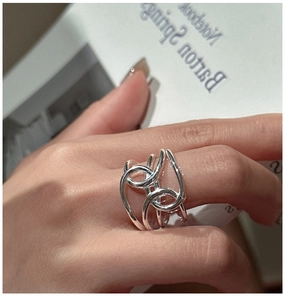Close-up of minimalist S925 sterling silver multilayer intertwined ring worn on finger